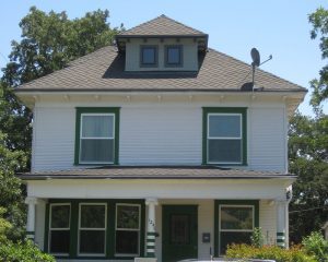 two story white home with green trim