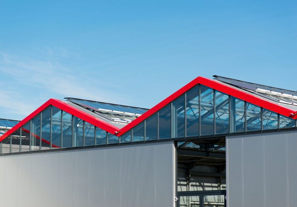 a large building with a red roof and glass windows