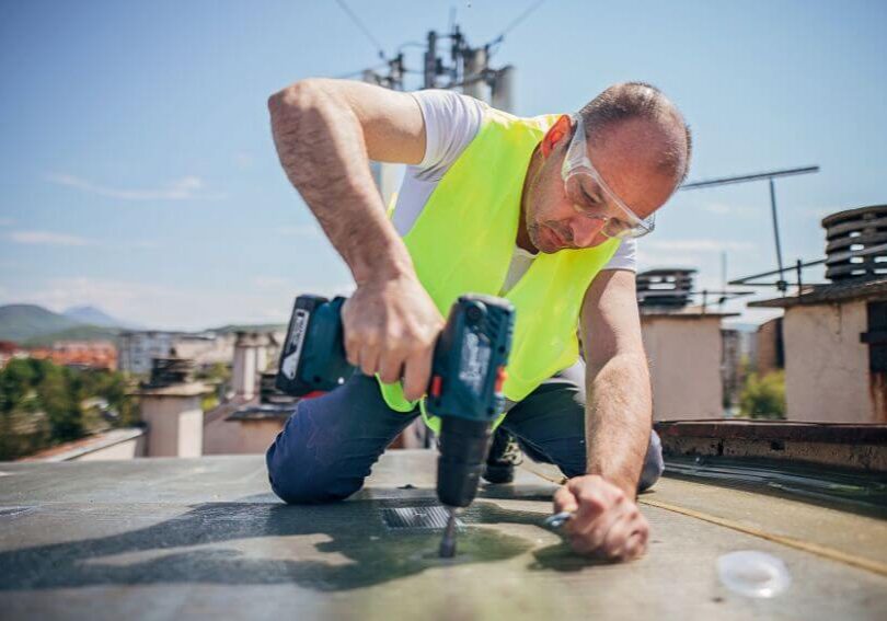 a man repairing a residential roofing