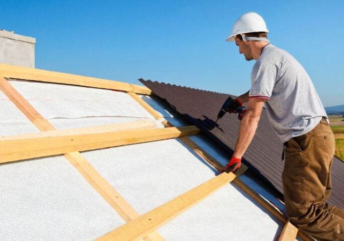 a man working on a roof with a ladder